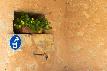 Drinking water faucet on old stone wall in Le Poet Sigillat