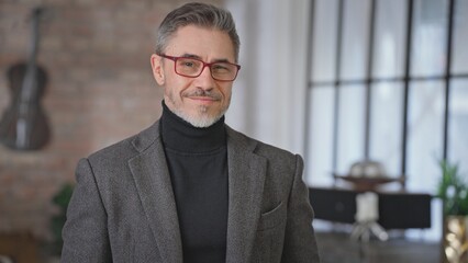 Portrait of happy confident mid adult businessman looking at camera, smiling. Middle aged man, male entrepreneur at home or office. Trust, success, skill and reliability in business.