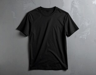 Overhead shot of a plain, black, short-sleeved crew neck t-shirt, presented on a textured grey backdrop. The shirt is centered and isolated