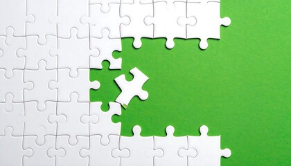 Overhead shot of a puzzle nearly completed, with a single piece out of place and a vibrant green background. Shows connection