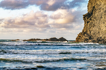 Fototapeta premium Evening skies and surf at Crackington Haven beach