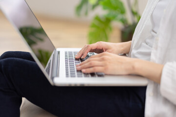 Close-Up of Woman's hands Typing on Laptop While Sitting on Sofa