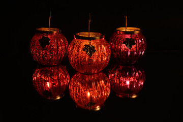 Pumpkin shaped tea light holder with reflection. 