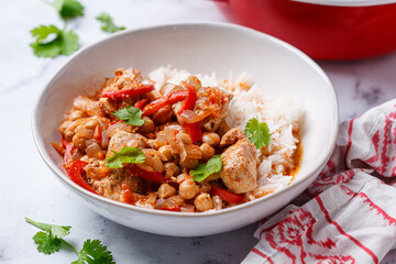 Tikka masala with chicken, chickpeas and rice in bowl.