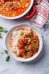 Tikka masala with chicken, chickpeas and rice in bowl.