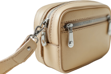 A detailed shot of a rectangular, beige bag with a silver zipper and a strap