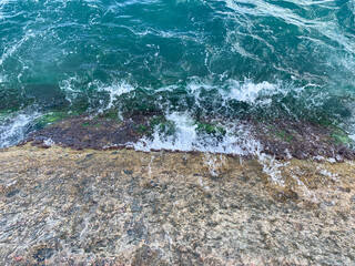 sea wave splashing on the rocks on the shore.