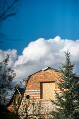 Rustic Dacha House Gable with Ornate Security Bars in Autumn Foliage