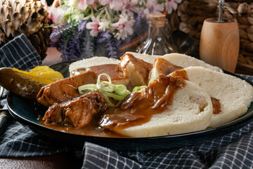 Czech dumplings with stewed pork in sauce.