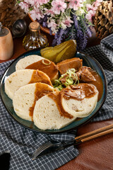 Czech dumplings with stewed pork in sauce.