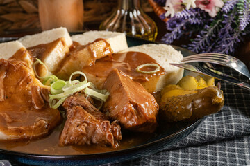Czech dumplings with stewed pork in sauce.