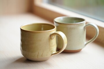 Two ceramic mugs in soft colors, perfect for cozy coffee moments