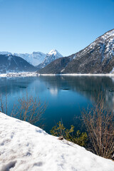 blue lake Achensee in winter. view to Pertisau and Dristenkopf mountain, austria