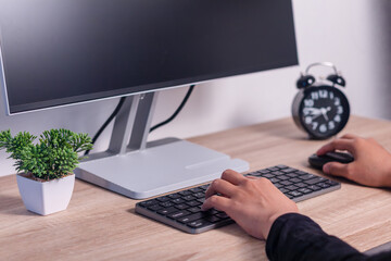 Close up of a woman working or studying on computer. Female hands on computer keyboard and mouse.