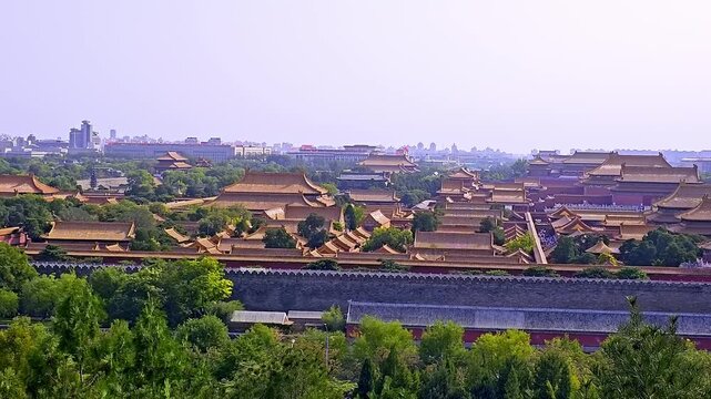 Aerial view of Forbidden City imperial palace with traditional Chinese architecture, golden roofs, ancient buildings surrounded by lush greenery in Beijing, China.