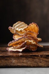 Apple chips on a dark background.