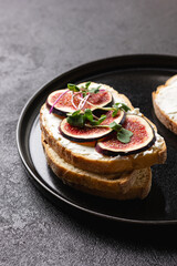 White bread with young cream cheese, freshly sliced figs and radish sprouts.