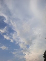 Softly lit clouds against a blue sky