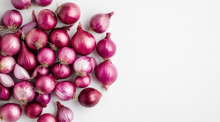 Fresh, vibrant purple onions clustered on a white surface