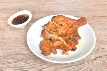 roasted chop chicken meat tight and leg on plate dipping with sweet and spicy sauce