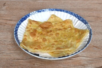fried roti southern flat bread on white paper tray in plate