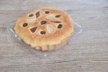 castella cake topping raisin and fruit sweet food on plastic tray