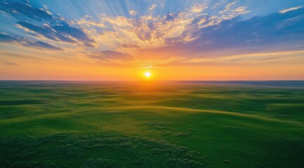 Sunrise over a vast grassy plain
