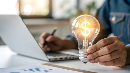 Businessman holding glowing light bulb with dollar sign. Finance, innovation, and creative idea concept.
