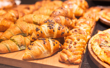 Delicious sweet pastries, croissants, on display in a cafe