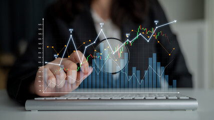 A business professional examines financial data on a laptop, highlighting market trends and growth...
