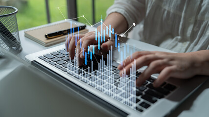 A woman in a white shirt focuses on typing on a laptop while surrounded by an engaging data visualization. This modern office setting emphasizes productivity and analytics. Scalp