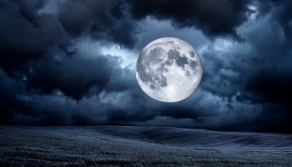 Fototapeta premium a full moon shrouded in dark stormy clouds