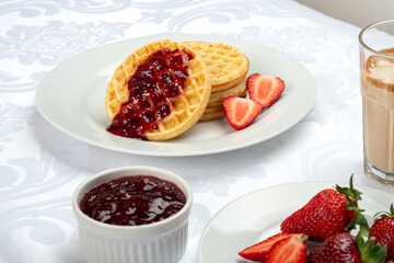 Delicious Waffles with Strawberry Jam and Fresh Berries for Breakfast