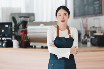 Confident smiling young Asian woman owner of small business cafe. proud entrepreneur and barista...