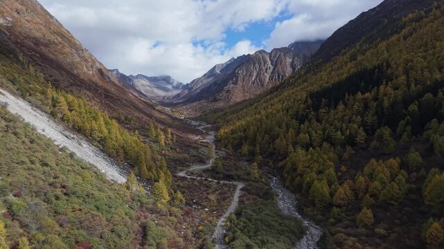Aerial Drone Fly-Through of Alpine Valley with Autumn Colors and Snow Mountains Western Sichuan, China