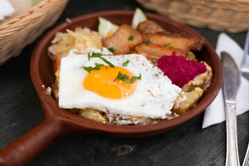 Breakfast dish - scrambled eggs with fried bacon