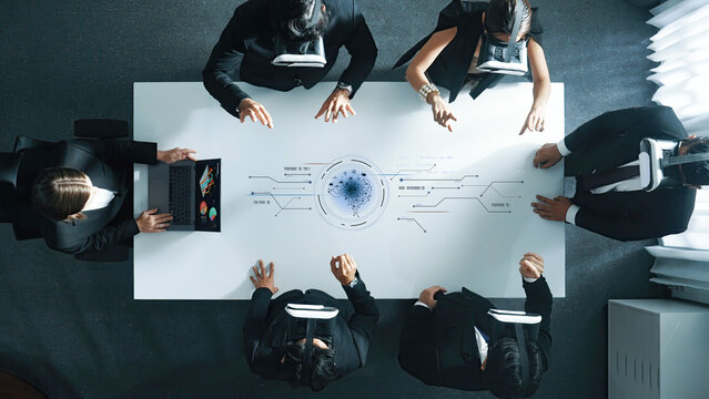 Aerial view of business professionals using virtual reality in a modern conference room. This dynamic setting enhances collaboration, creativity, and innovative strategies for the future. Trope - Powered by Adobe