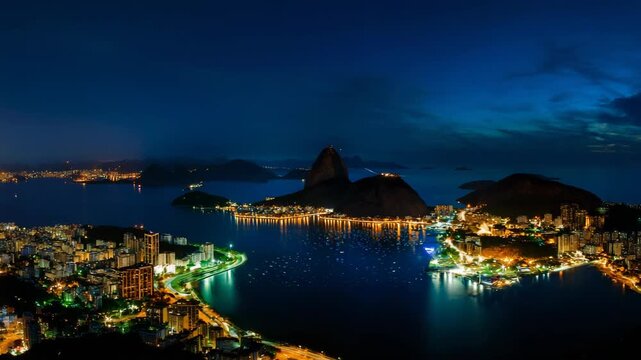 Night view of Rio de Janeiro with Sugarloaf Mountain and city lights.