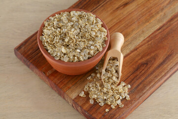 gluten-free millet Jowar (Sorghum) flakes in wooden bowl,Close up