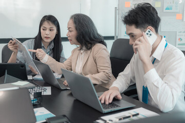 Fototapeta premium Group of business people discussing charts and graphs showing results of teamwork of colleagues working together at desks in office and discussing documents.