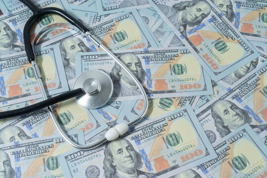 Business concept with a stethoscope on dollar banknote
