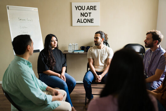 Hispanic people sharing feelings in mental health support group