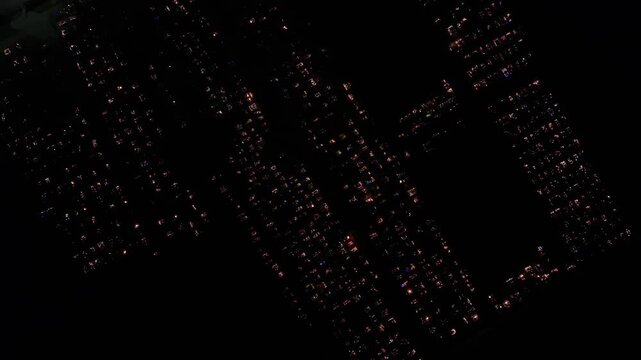 Aerial view of a Polish cemetery on All Saints&rsquo; Night, glowing with thousands of candles that honor the dead and illuminate the darkness with warmth and faith.