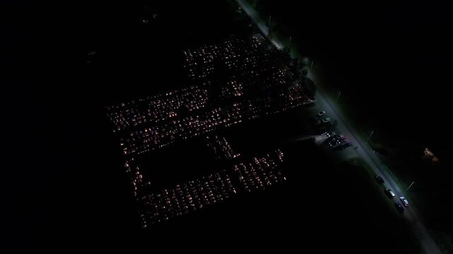Aerial view of a Polish cemetery on All Saints&rsquo; Night, glowing with thousands of candles that honor the dead and illuminate the darkness with warmth and faith.