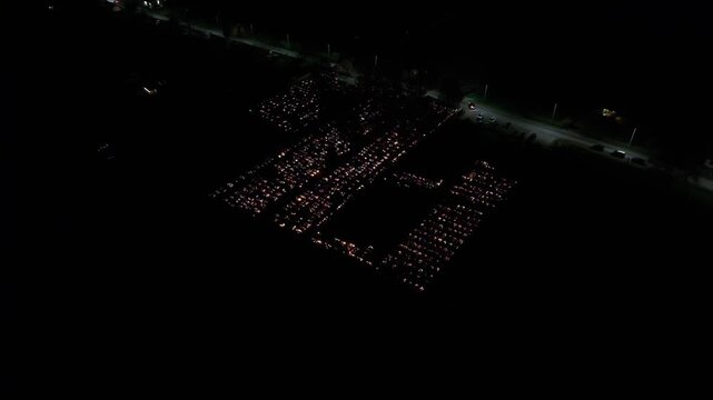 Aerial view of a Polish cemetery on All Saints&rsquo; Night, glowing with thousands of candles that honor the dead and illuminate the darkness with warmth and faith.