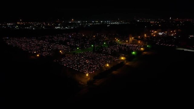Aerial view of a Polish cemetery on All Saints&rsquo; Night, glowing with thousands of candles that honor the dead and illuminate the darkness with warmth and faith.
