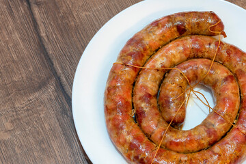 baked sausage. Homemade Pork sausage. Homemade sausage on the plate