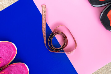 different sneakers,  colored  surface. sport shoes, Fitness accessories. Measuring tape, centimeter.