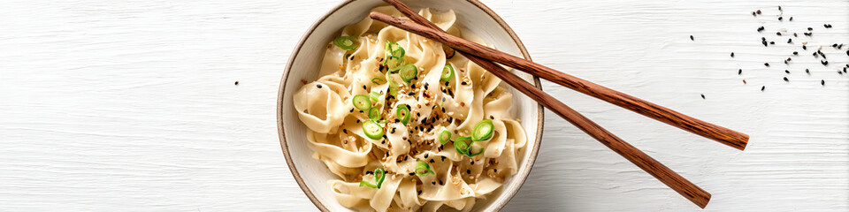 Wide layout featuring a bowl of hand-pulled noodles garnished on transparent background