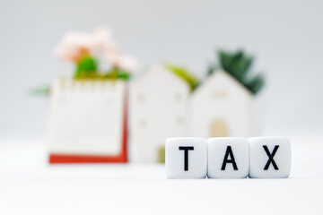 Tax Season: TAX Spelled with Dice placed in the picture of  White Surface and blurred background and foreground digitally generated image stock photo copy space